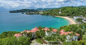 A coastal resort with a beach, clear blue waters, and lush greenery. - Sandals Regency La Toc (Castries)