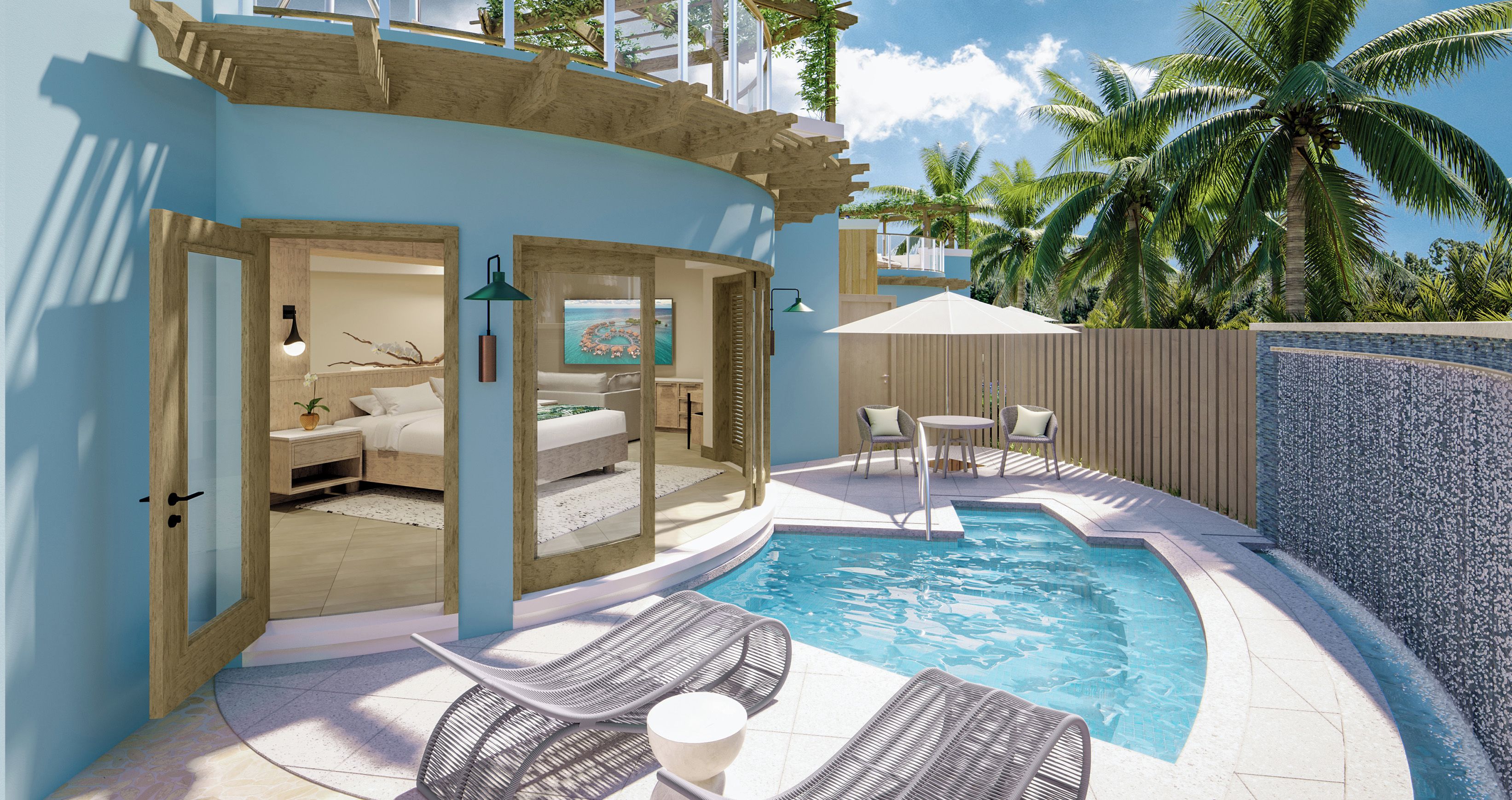 A pool area with lounge chairs, a small table, and a view of the ocean.