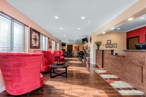 A hotel lobby with red seating, a reception desk, and a tiled floor. - Econo Lodge Gadsden Area (Grant)