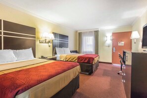A hotel room with two beds, a desk, a TV, and a bathroom door. - Econo Lodge Gadsden Area (Grant)