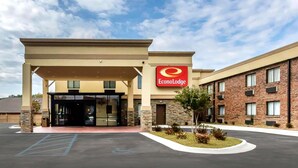 A hotel entrance with a covered area, a parking lot, and a landscaped garden. - Econo Lodge Gadsden Area (Grant)