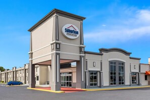 A Suburban Extended Stay Hotel with a beige facade, large windows, and a prominent entrance. - Suburban Studios Chester I-95 (Chester)