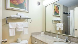 A bathroom with a toilet, sink, and towel rack. - Suburban Studios Chester I-95 (Chester)