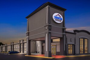 A Suburban Extended Stay Hotel with a modern architectural design, featuring a prominent entrance and a parking area. - Suburban Studios Chester I-95 (Chester)