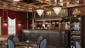 A bar area with a high counter, multiple wine bottles, and a seating area with chairs and a table. - Botel Albatros (Prague)