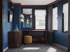 Una habitación con un ventanal grande, un espejo, un armario y un suelo estampado.