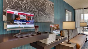 A hotel reception desk with a computer, printer, and a map on the wall. - Pear Tree Inn Airport St. Louis - St. Ann (St. Ann)