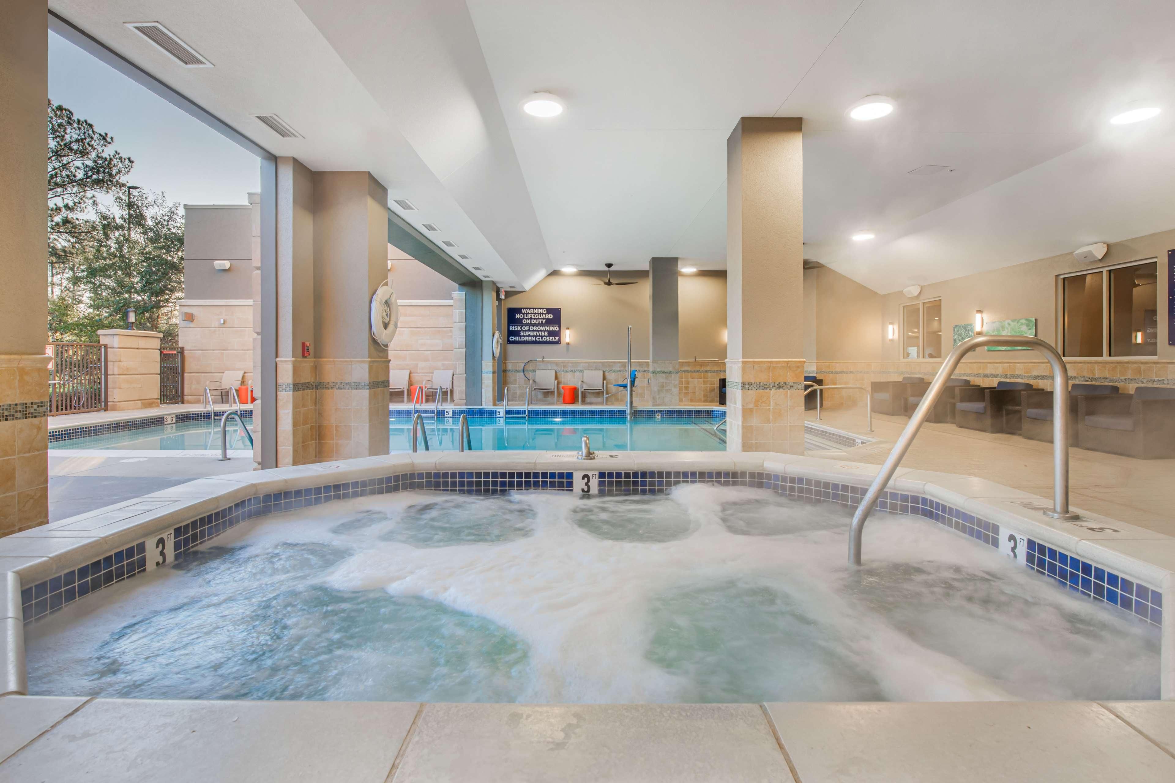 A hot tub area with a pool, a sign indicating a 3-meter depth, and a view of the outside.