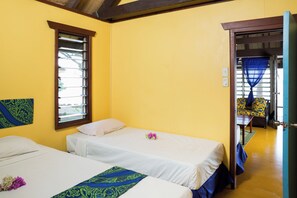 A room with two beds, a window, and a view of another room. - Funky Fish Beach Resort (Malolo Island)