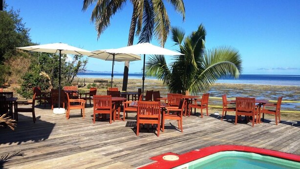 A wooden deck with outdoor seating and a pool. - Funky Fish Beach Resort (Malolo Island)