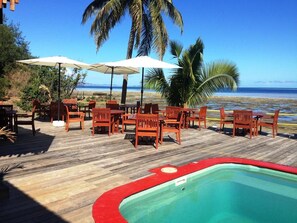 A wooden deck with outdoor seating and a pool. - Funky Fish Beach Resort (Malolo Island)