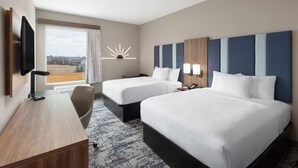 A hotel room with two beds, a desk, a TV, and a large window with a view. - La Quinta Inn & Suites by Wyndham Athens I-65 (Athens)