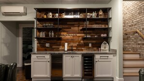 A kitchen with white cabinets, a built-in oven, and a brick wall.