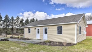 A single-story house with a gabled roof, a front door, and a small porch. - Gather and Celebrate · Poconos Escape (Pleasant Mount)