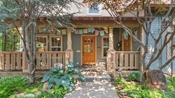A house with a front porch, a wooden door, and a stone pathway leading to the entrance. - Luxury home in North End Boise (Boise)