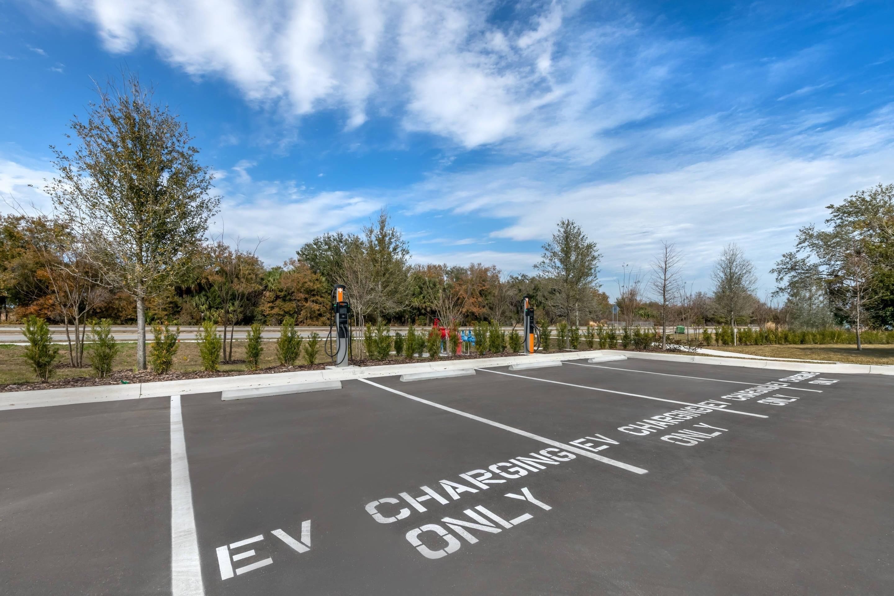 A parking lot with EV charging stations marked on the ground.