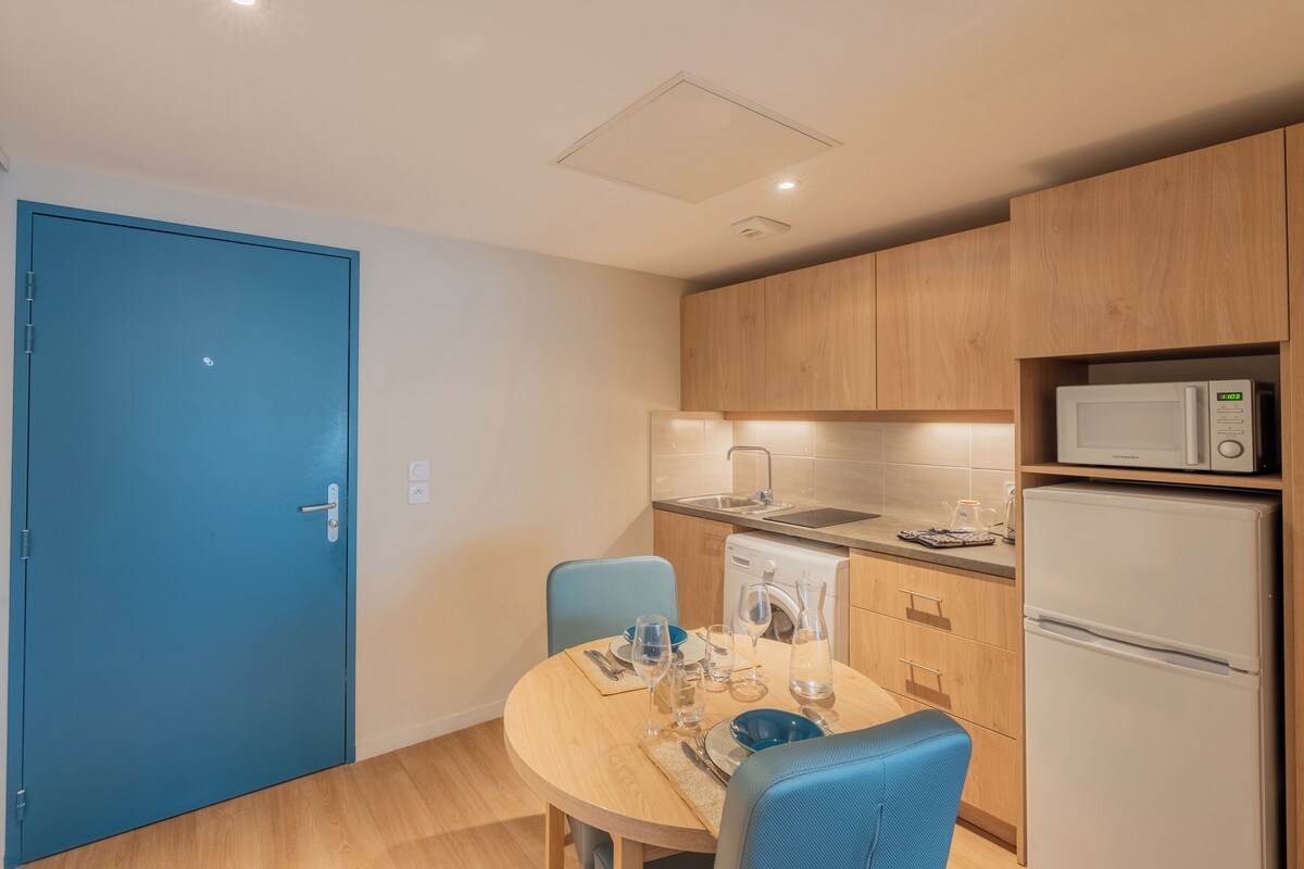A compact kitchen with a microwave, sink, and dishwasher.