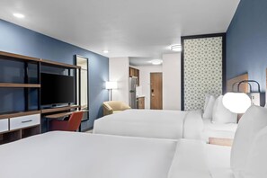 A hotel room with a bed, a desk with a TV, a chair, a lamp, and a wardrobe. - Everhome Suites Bowling Green by Choice Hotels (Bowling Green)