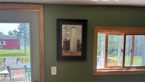 A room with a door, a window, and a framed picture on the wall. - Back to the Old Farm (Ashland)