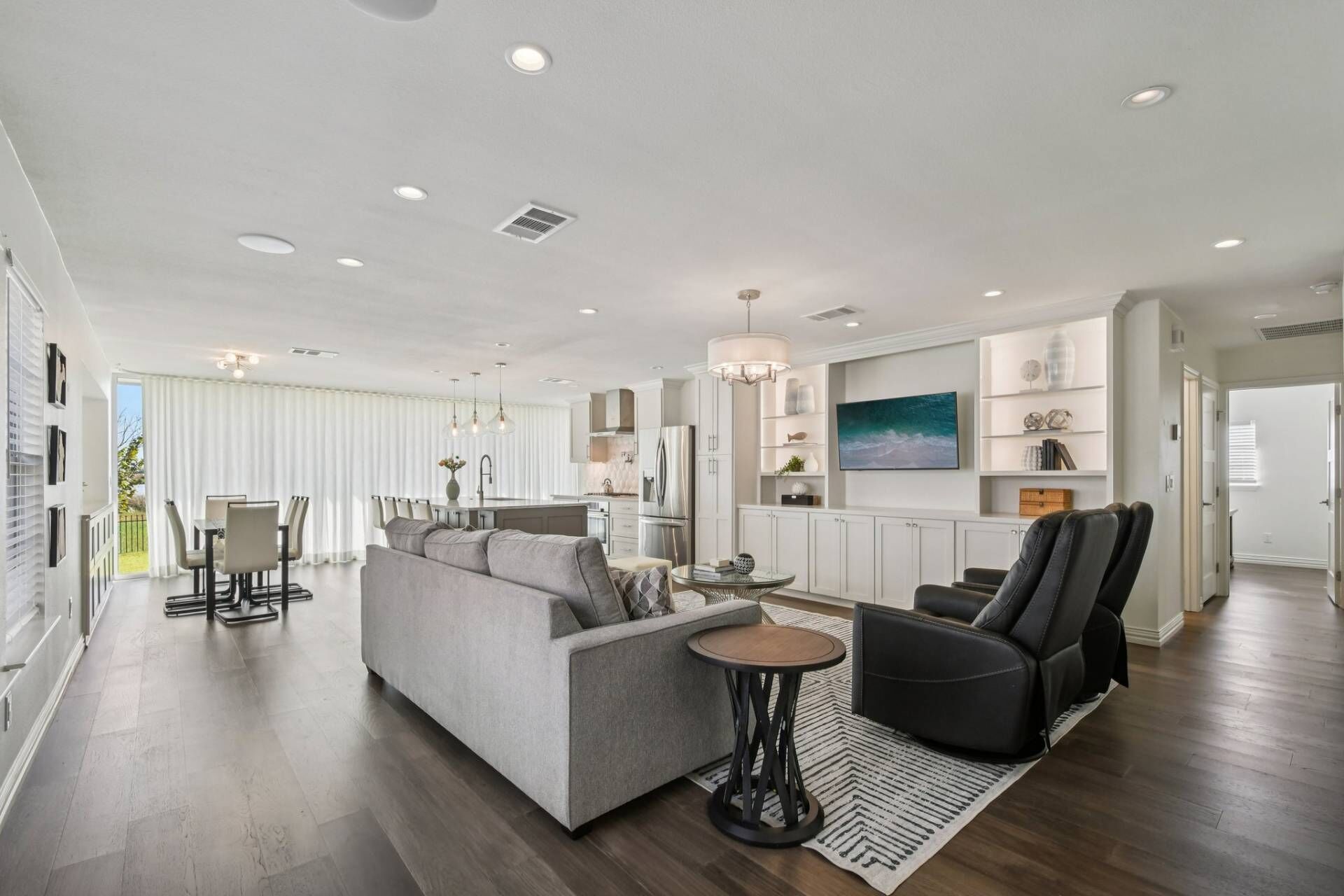 Open concept living room, dining room and kitchen with TV