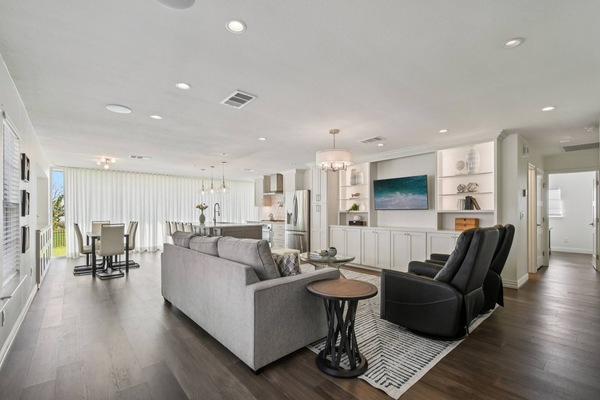 Open concept living room, dining room and kitchen with TV