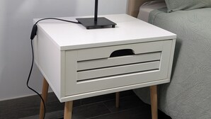 A bedside table with a lamp, a drawer, and a power cord. - Apartment near the airport, The Greey's house D (El Calero)