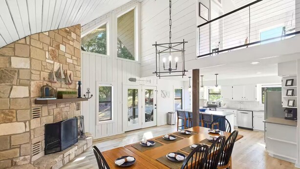 A spacious kitchen with a central island, large windows, and a high ceiling. - NEW! Lake View • Pool + Spa • Game Room • Fire Pit • Near Marina & Wineries (Canyon Lake)