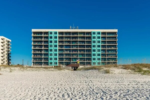 A multi-story hotel with a flat roof and a central entrance.