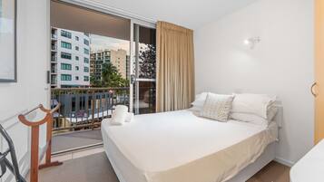 Desk, iron/ironing board, bed sheets