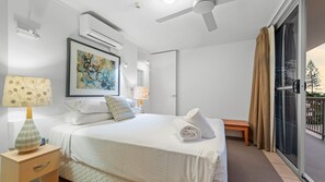 Desk, iron/ironing board, bed sheets