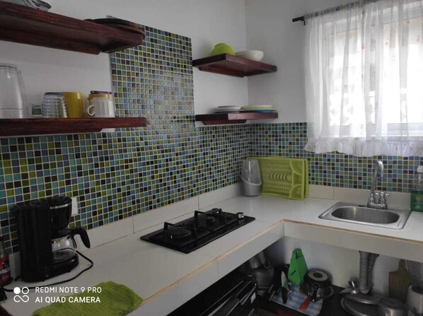 Fridge, stovetop, coffee/tea maker, cookware/dishes/utensils