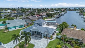 A residential area with houses, a marina, and a bridge in the background. - 19th Place Paradise Awaits! (Cape Coral)