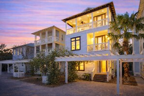 A two-story house with a balcony, a covered porch, and a staircase leading to the entrance. - DOCTORS ORDERS Luxury 30A Retreat Gulf Views Steps to Beach Seacrest Escape (Inlet Beach)