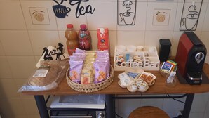 Una mesa con diferentes alimentos, como pan, pasteles y productos de café.