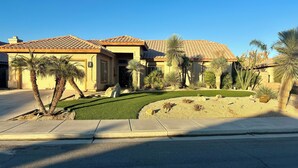 A residential area with houses featuring tiled roofs and palm trees. - Luxury Desert 3BR house with Private Pool & Spa (La Quinta)