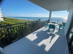 A balcony with a view of the beach and ocean. - Oceanfront updated corner 2/2 condo with wrap around balcony on 4th floor (Jensen Beach)