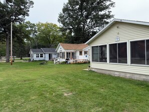 A two-story house with a covered porch and a large windowed front.