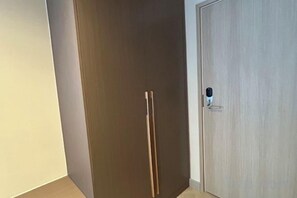 A closed door with a handle and a lock mechanism. - The One Cozy Living (Pattaya)