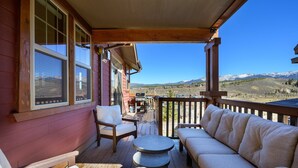 A wooden deck with a sofa, chairs, and a table. - Downtown Winter Park Area Condo H-201 I Great Views I Bunk Room I Discounted Attractions (Fraser)