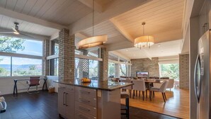 A modern kitchen with a central island, large windows, and a dining area. - New Listing Vast Red Rock Views 2 Master Suites - Panorama Landing (Sedona)
