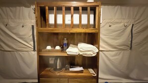 A bunk bed with a wooden headboard, a shelf with toiletries, and a small cabinet below. - Cay Sao Beach Glamping Phu Quoc (Phu Quoc)