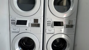 A pair of commercial duty washers with digital displays and control panels. - Clewiston Comfort #4 – Stylish 1BR Hideaway (Clewiston)