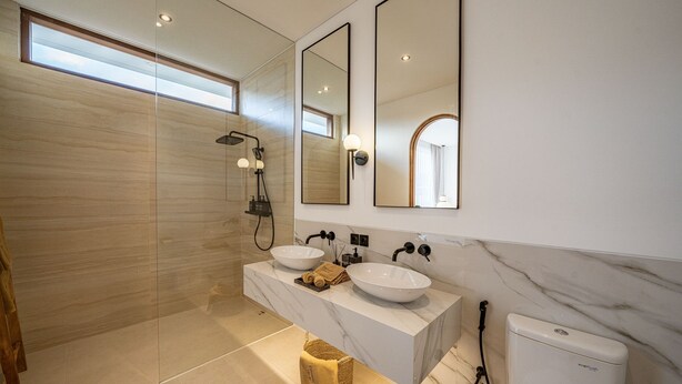A modern bathroom with two sinks, a shower, and a toilet. - Elements B2 Villa Bingin (Pecatu)