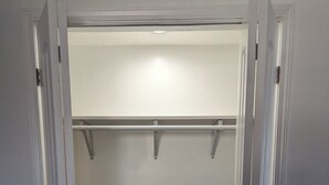 A walk-in closet with a wooden floor and white walls. - Charming 1-bedroom apartment in welcoming Pittsburgh with AC (Pittsburgh)