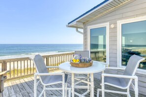 A deck with two chairs and a table, overlooking the ocean. - Spacious Beachfront House, Breathtaking Ocean Views, Near Historic Attractions, $300 in Free Tickets (St. Augustine)