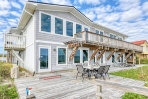 A large, two-story house with a wooden deck and outdoor seating area. - Spacious Beachfront House, Breathtaking Ocean Views, Near Historic Attractions, $300 in Free Tickets (St. Augustine)
