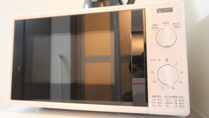 A white microwave with a digital display and control panel. - Small-Town Feel, Big-City Access | Homey Stay in Nakano (中野区野方)