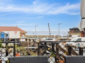 A parking lot with various vehicles, including cars and trucks, and a building with a red roof in the background. - 5 Star Holiday Home in Soby Aero (Soby)