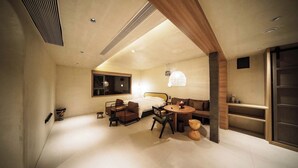 A modern bedroom with a bed, a desk, a chair, and a round table. - NO.9 Alley Yuchen Res Dence (Guilin)