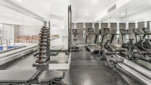 A gym with treadmills, stationary bikes, and free weights. - 2-Bed City Retreat with Gym and Pool Access (Adelaide)